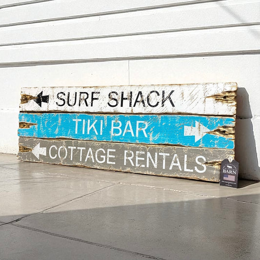 Rustic coastal wooden sign for beach house wall decor with arrows to Surf Shack, Tiki Bar, and Cottage Rentals, handcrafted by The Unpolished Barn LLC