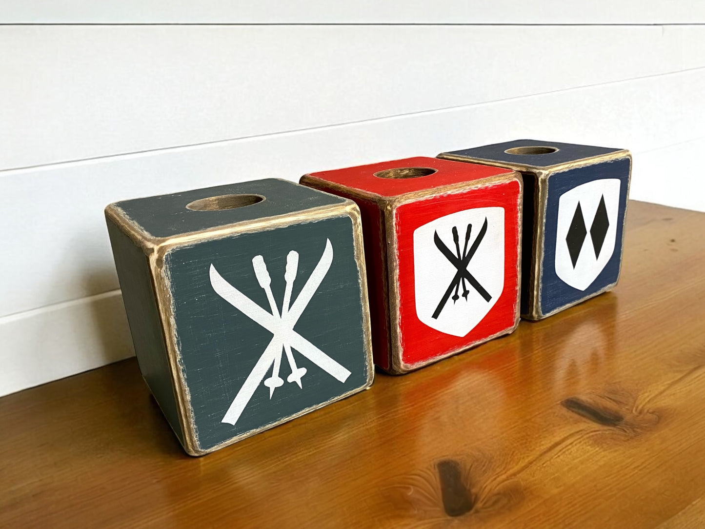 Rustic ski lodge tissue box set with vintage crossed ski and double diamond emblems, handcrafted wooden covers in red, navy, and green, cozy ski cabin decor handmade in Maine.