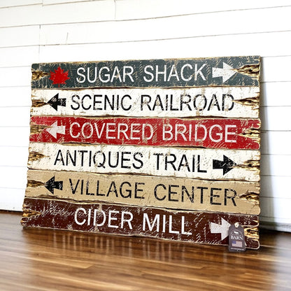 Rustic wooden signs with arrows to Sugar Shack, Scenic Railroad, Covered Bridge, Antiques Trail, Village Center, and Cider Mill, handcrafted distressed farmhouse and cabin decor by The Unpolished Barn LLC.