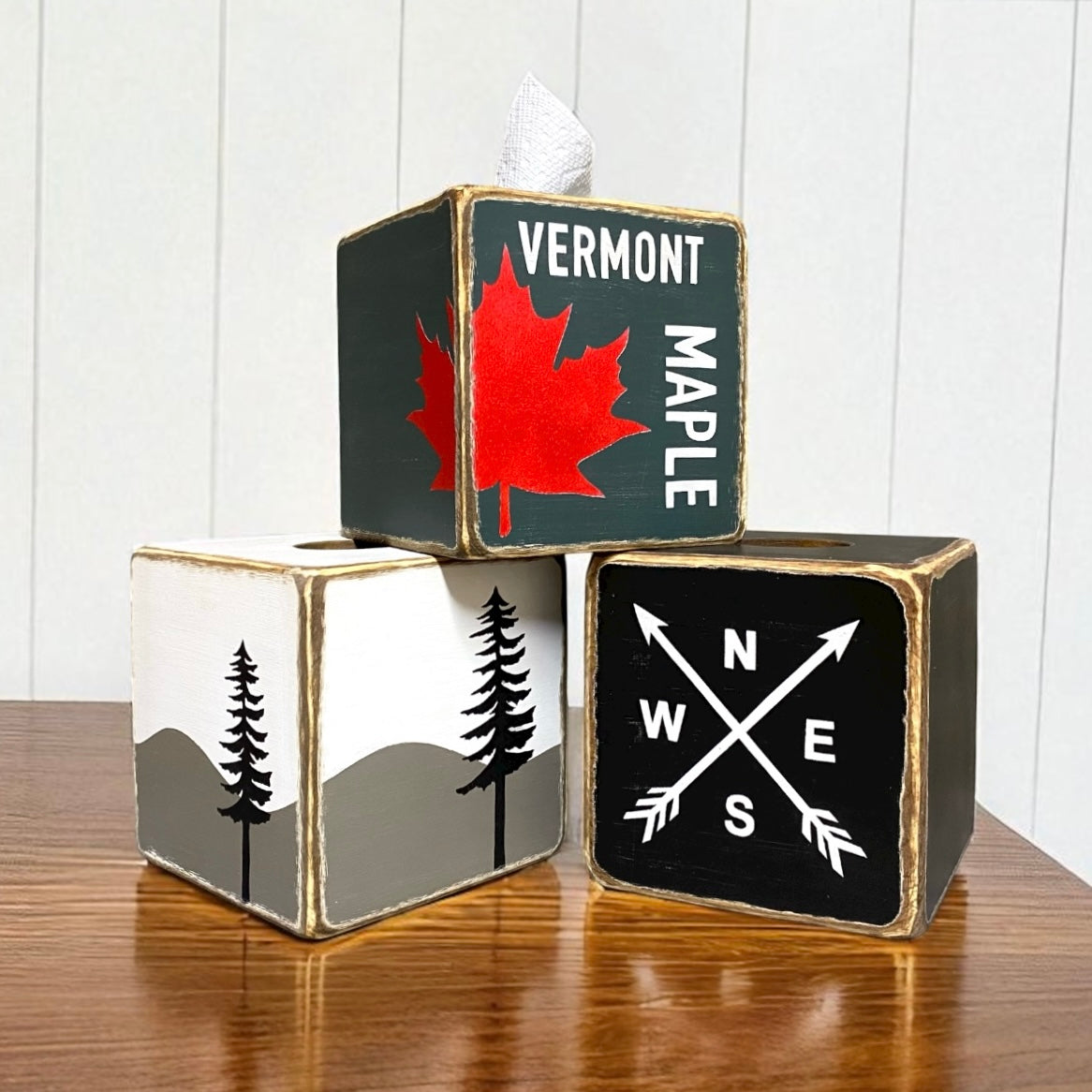 Rustic wooden tissue box covers with Vermont maple leaf design, compass arrows, and mountain tree silhouette artwork, farmhouse cabin style home décor