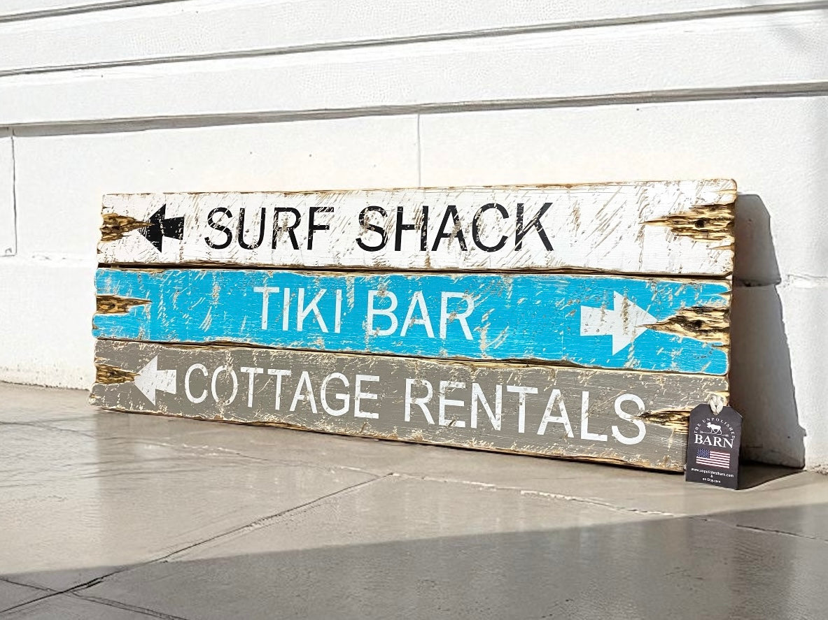 Hand-painted beach cottage sign with distressed arrows to Surf Shack, Tiki Bar, and Cottage Rentals, rustic coastal wall decor by The Unpolished Barn LLC