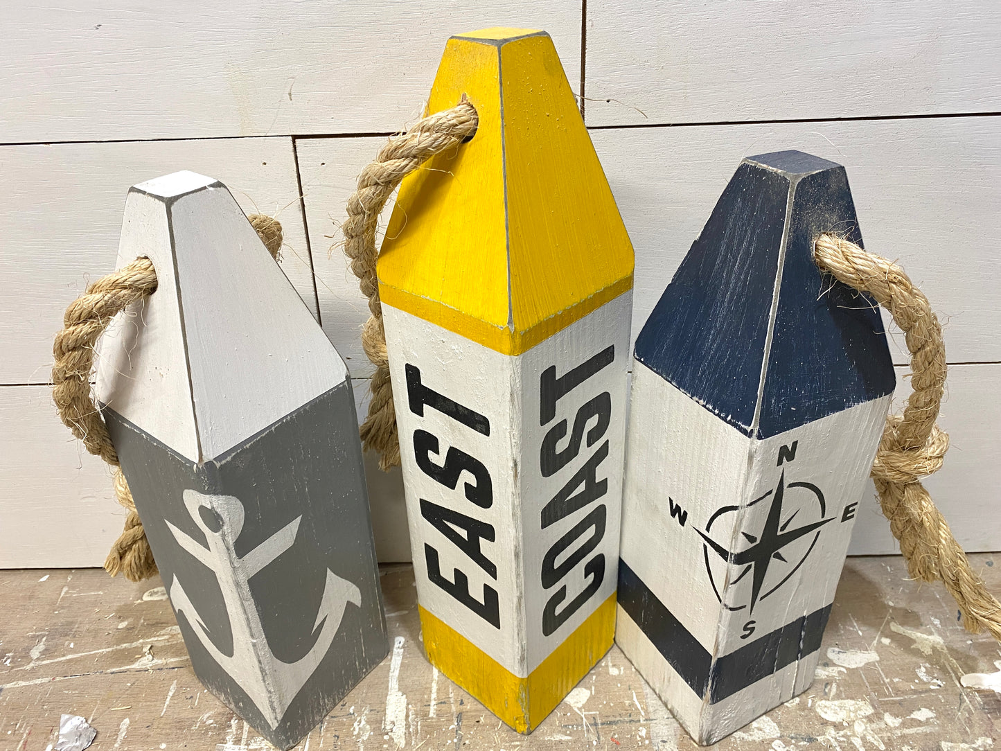 Detailed view of East Coast wood buoy decor featuring nautical artwork, weathered finish, and handmade coastal character. Perfect for beach house decor, coastal homes, and ocean-inspired rooms