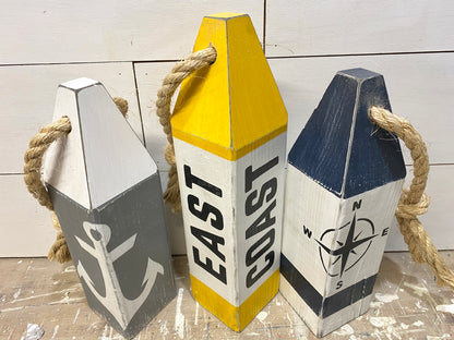 Detailed view of East Coast wood buoy decor featuring nautical artwork, weathered finish, and handmade coastal character. Perfect for beach house decor, coastal homes, and ocean-inspired rooms