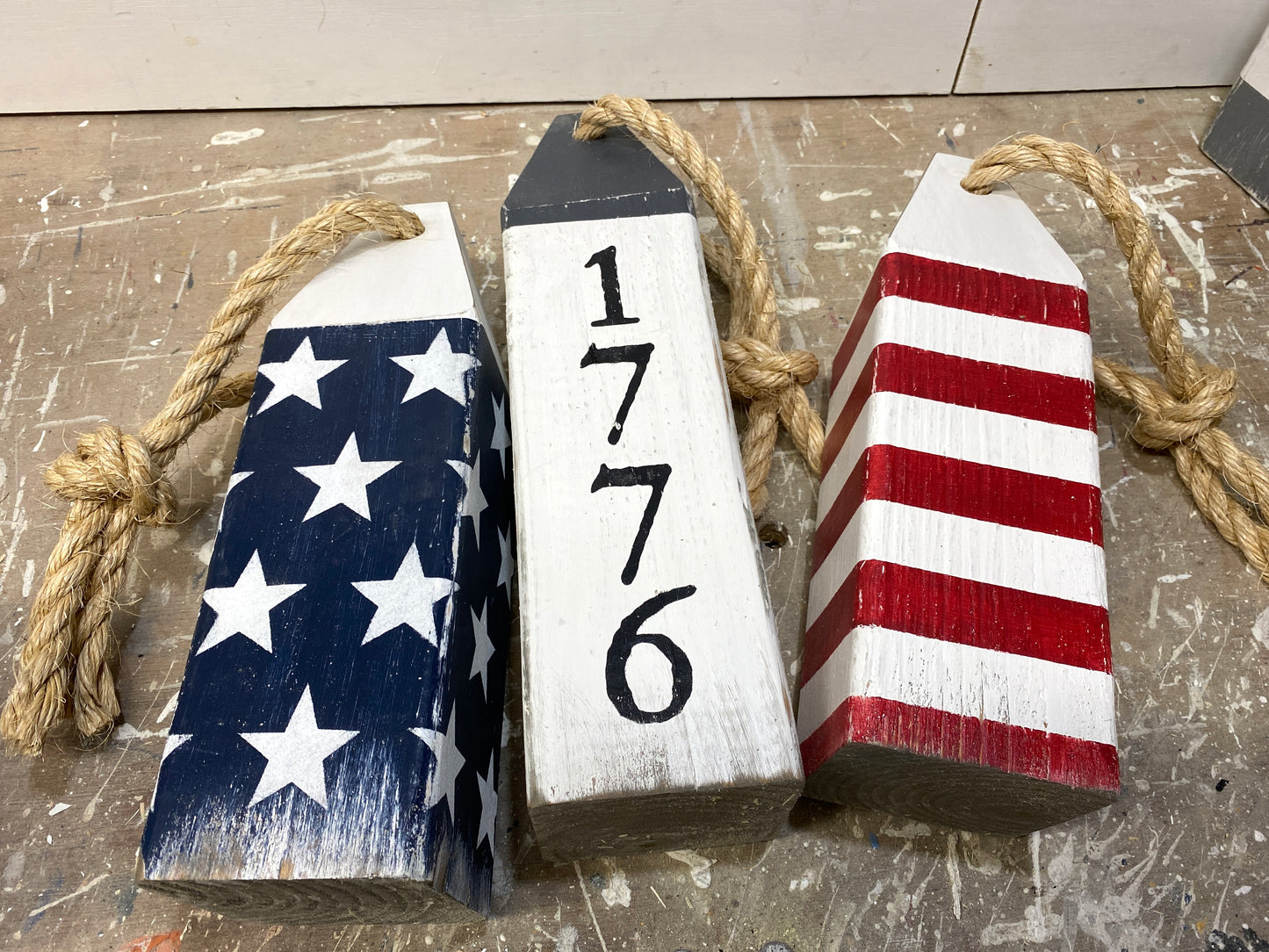 Detailed view of patriotic wood buoy decor featuring 1776 American flag design, handmade painted details, and rustic nautical character. Perfect for coastal homes, beach house decor, and Americana spaces
