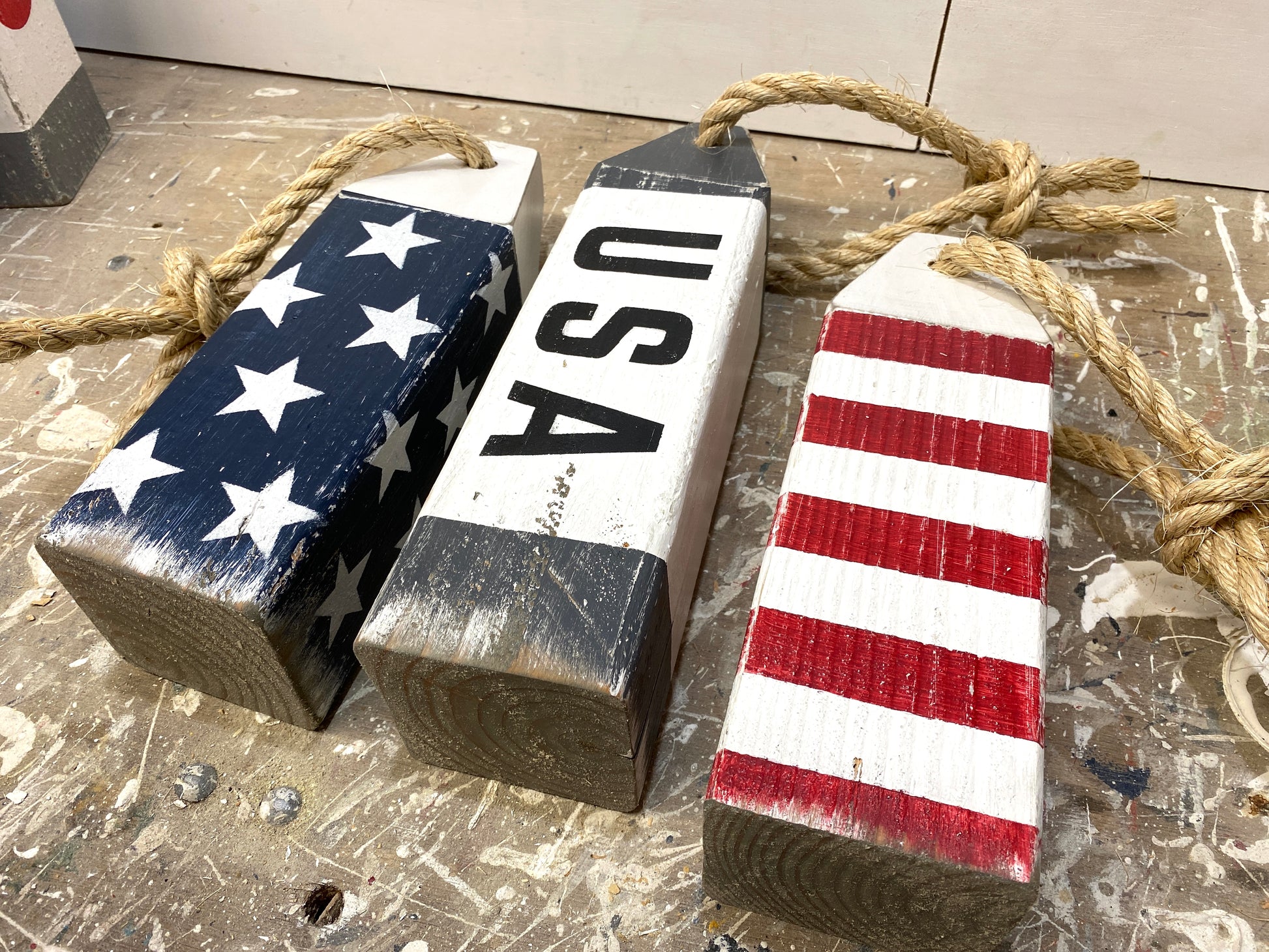 Detailed view of USA wood buoy decor featuring American flag design, handmade painted details, and nautical character. Coastal accent for beach houses, boats, waterfront homes, and Americana spaces