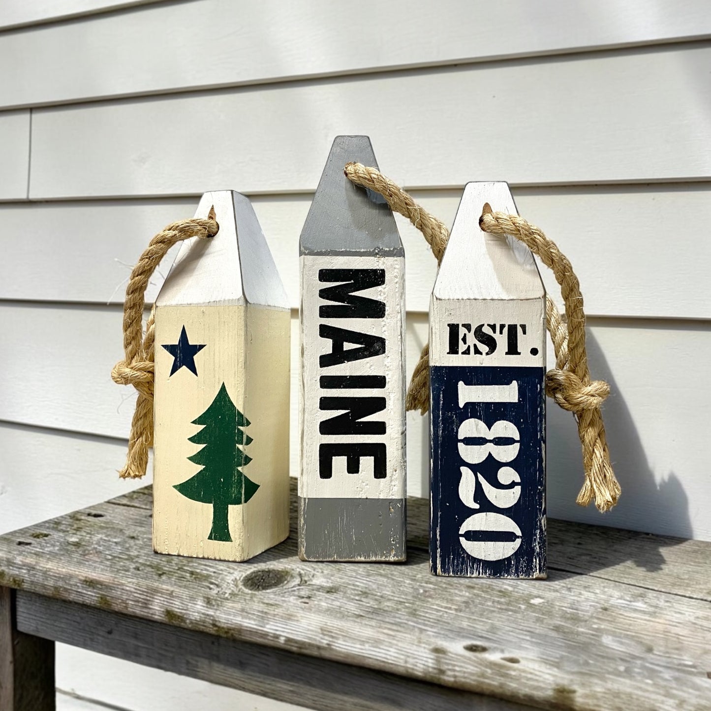 Decorative Maine nautical buoy set displayed in a coastal home with rustic seaside decor. Perfect for New England coastal homes, beach cottages, harbor-inspired rooms, and waterfront spaces
