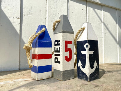 Pier 5 nautical lobster wood buoy featuring hand-painted anchor design and distressed wood finish. Coastal decor for beach houses, nautical homes, waterfront cottages, boating spaces, sailing gifts, harbor decor, and New England coastal style.