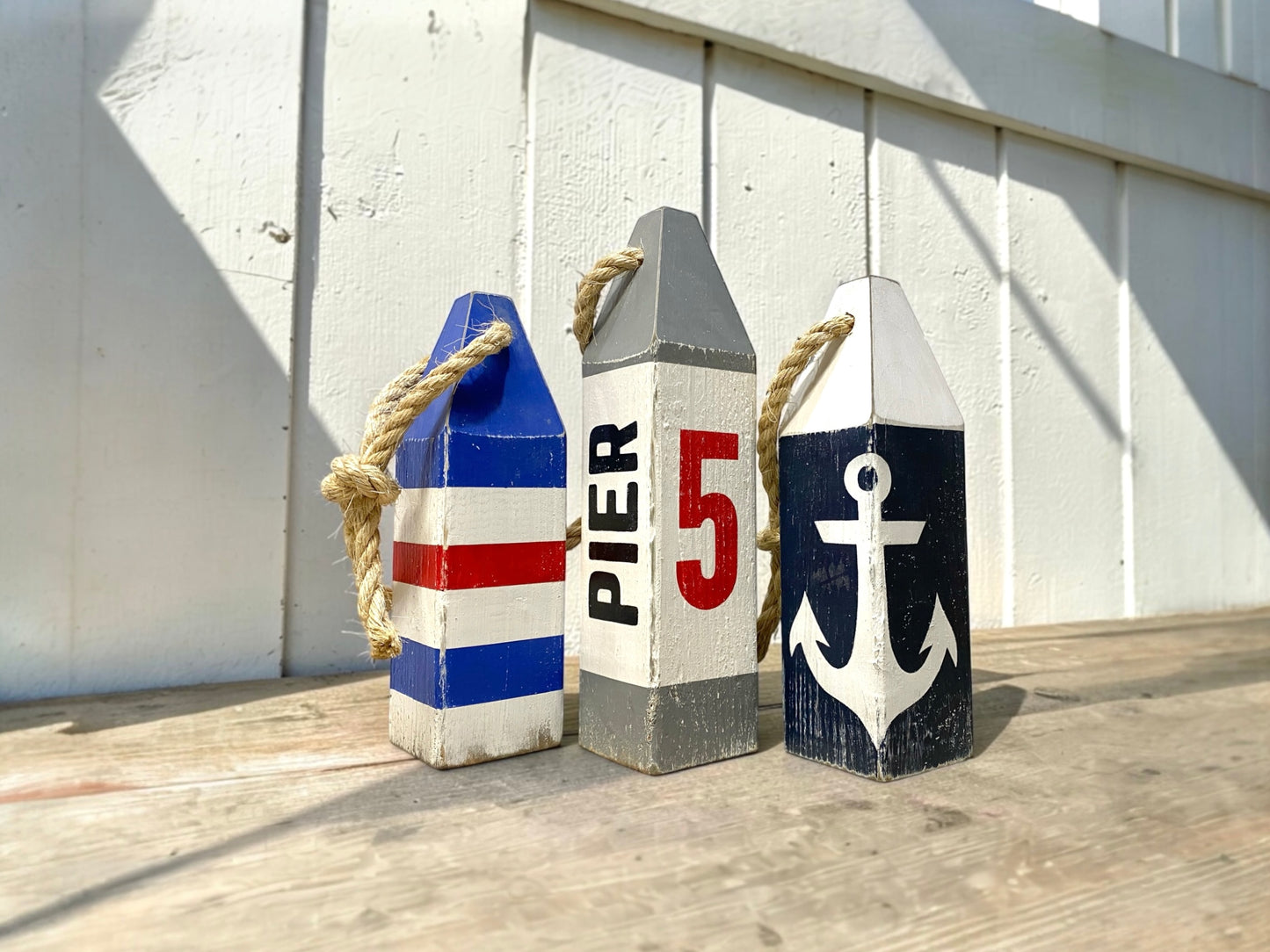 Pier 5 nautical anchor buoy displayed in a coastal home with rustic nautical decor. Handmade wood decor for beach houses, lake homes, waterfront retreats, boating lovers, and sailing enthusiasts