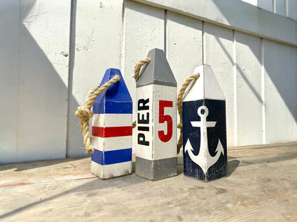 Pier 5 nautical anchor buoy displayed in a coastal home with rustic nautical decor. Handmade wood decor for beach houses, lake homes, waterfront retreats, boating lovers, and sailing enthusiasts