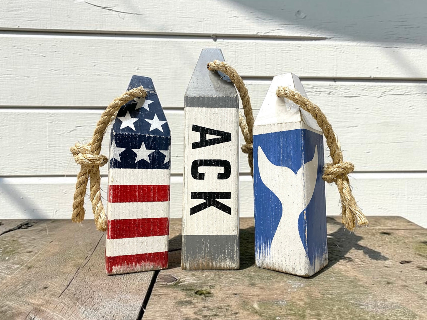 Detailed view of Nantucket wood buoy decor featuring coastal artwork, handmade painted details, and nautical character. Perfect for beach house decor, coastal homes, ocean-inspired rooms, and seaside cottages.