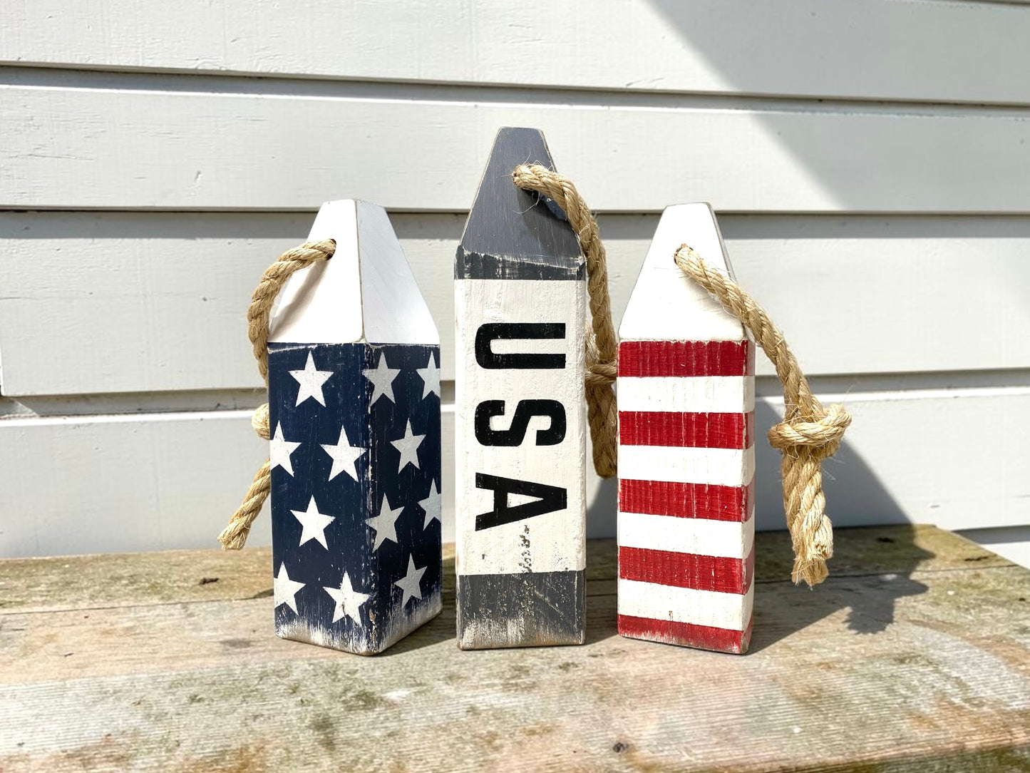 Decorative American flag buoy set displayed in a nautical home with coastal decor. Perfect for sailing lovers, boating spaces, beach houses, waterfront homes, and patriotic coastal style.