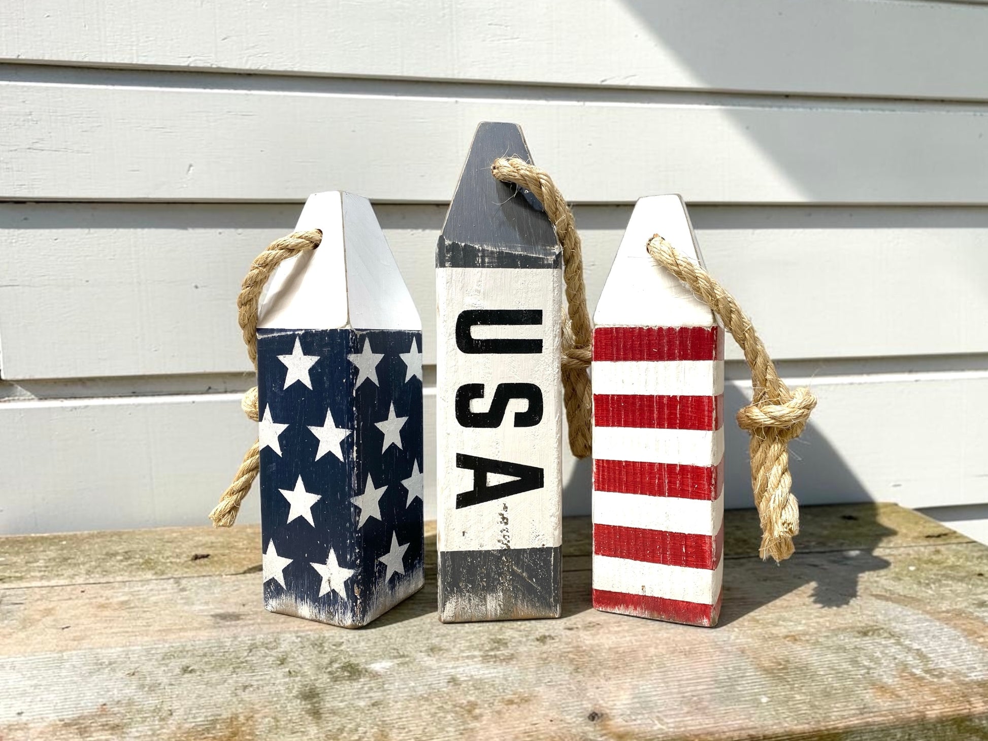 Decorative American flag buoy set displayed in a nautical home with coastal decor. Perfect for sailing lovers, boating spaces, beach houses, waterfront homes, and patriotic coastal style.
