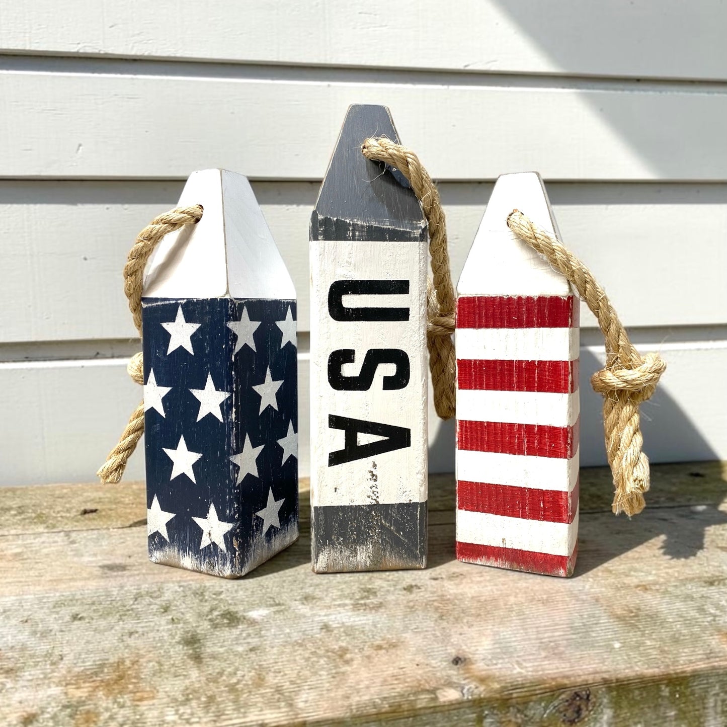 Decorative USA buoy set displayed in a beach house with patriotic nautical decor. Handmade wood accents for beach homes, coastal cottages, seaside rooms, and ocean-inspired spaces.