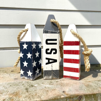 Decorative USA buoy set displayed in a beach house with patriotic nautical decor. Handmade wood accents for beach homes, coastal cottages, seaside rooms, and ocean-inspired spaces.