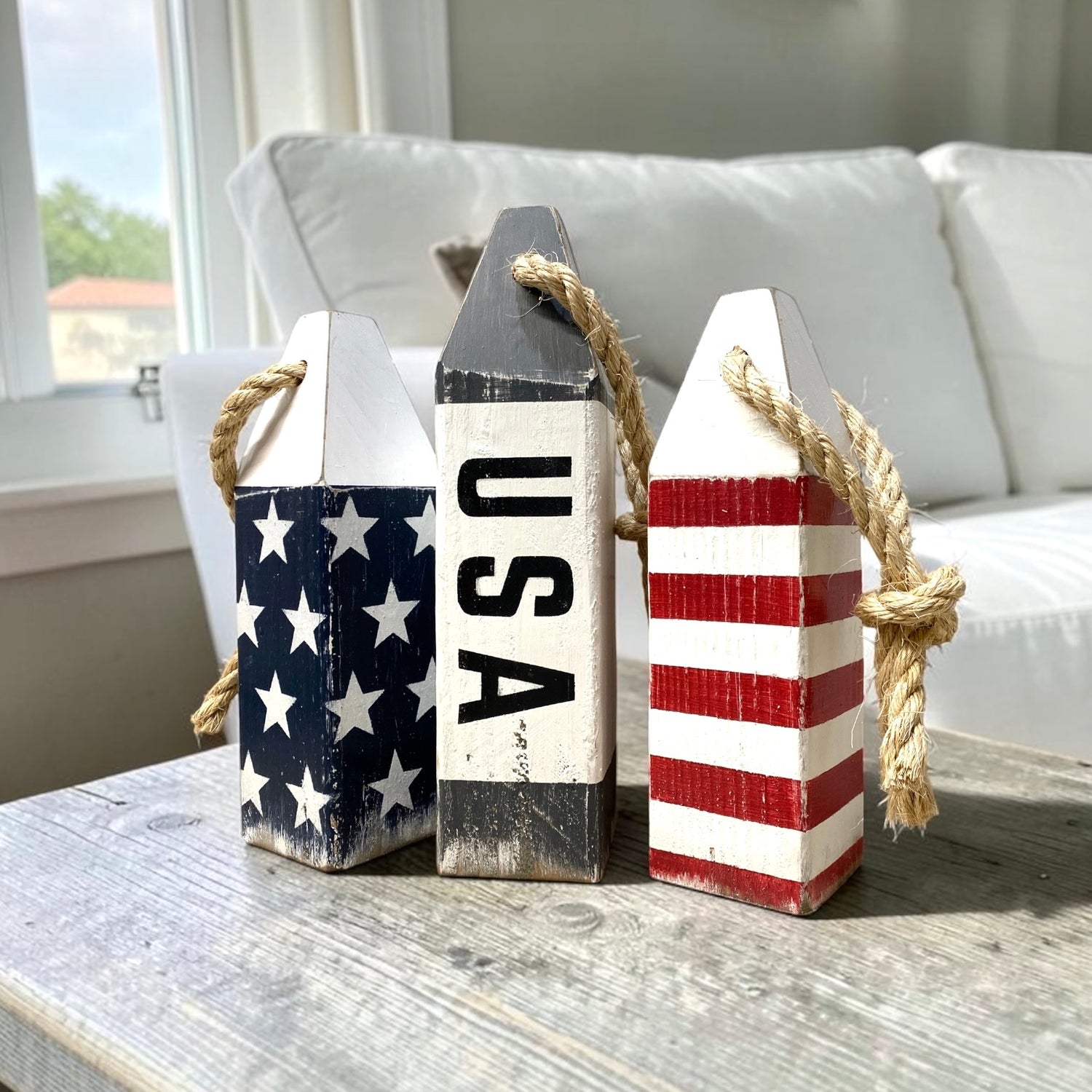 Decorative USA American flag wood buoy set featuring patriotic red, white, and blue hand-painted details with a distressed finish. Nautical coastal decor for beach houses, coastal homes, nautical rooms, boats, sailing spaces, and Americana decor