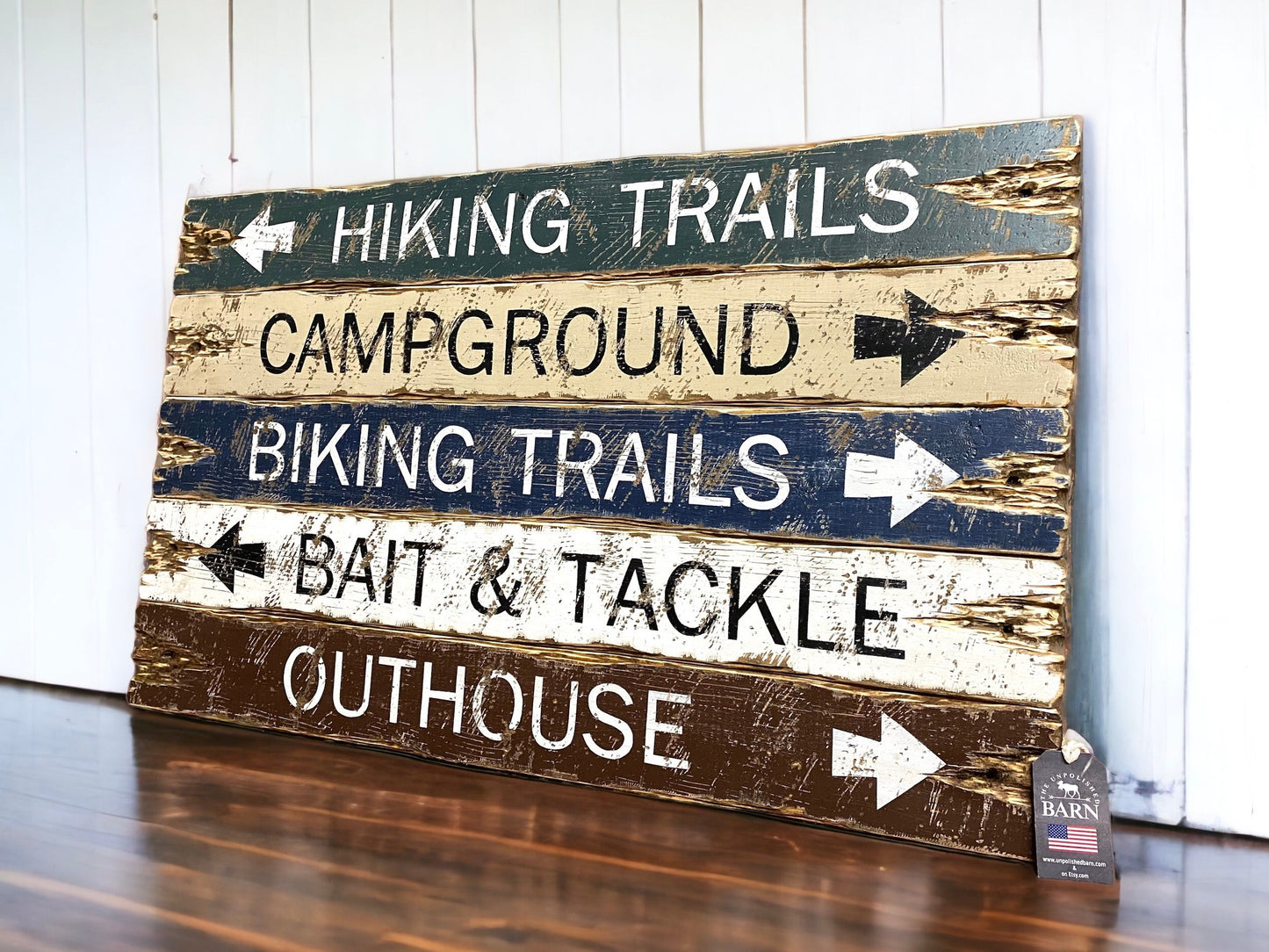 Hand-painted rustic outdoor sign in green, tan, and brown with arrows for Hiking Trails, Campground, Biking Trails, Bait & Tackle, and Outhouse, vintage distressed camping cabin wall art. handmade in Maine 