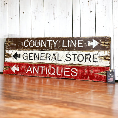 Rustic directional wood sign set reading “County Line,” “General Store,” and “Antiques,” in distressed brown, cream, and red paint, handcrafted farmhouse wall decor handmade in Maine by The Unpolished Barn LLC.
